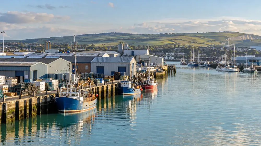 Commercial buildings and boats beside a Sussex harbour
